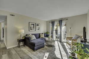 Living room/family room with sliding door that walks out to a balcony