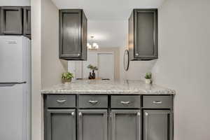 Kitchen looking into dining area and kitchen bar
