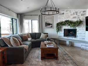Tiled living area with lofted ceiling and wood walls