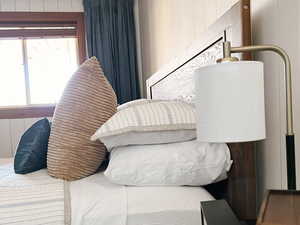Bedroom featuring crown molding and wooden walls