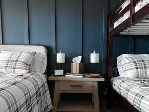 Bedroom featuring dark colored carpet