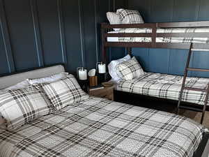 Bedroom with carpet and a decorative wall