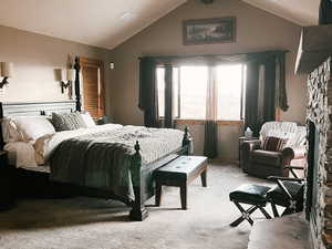 Bedroom with carpet floors, a stone fireplace, and recessed lighting