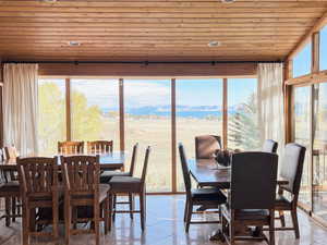 Dining room with wood ceiling and light tile patterned floors