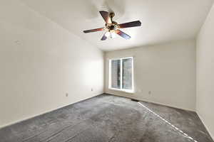 Empty room featuring carpet and a ceiling fan