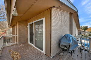 Wooden deck featuring a grill