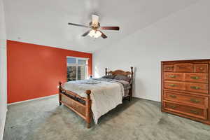 Bedroom featuring lofted ceiling, carpet floors, and a ceiling fan