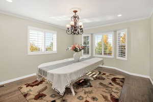 Dining room featuring crown molding, recessed lighting, and dark wood-style floors