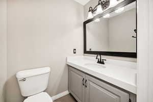 Half bath featuring vanity and tile patterned flooring