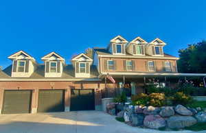 View of front of property with a front lawn, a porch, a garage, brick siding, and roof with shingles