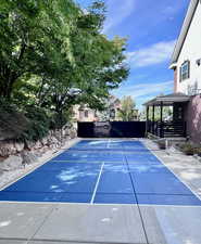 View of pickleball court featuring a patio