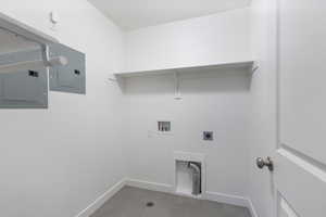 Laundry area featuring electric panel, light tile patterned floors, washer hookup, and hookup for an electric dryer