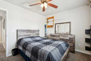 Bedroom with dark carpet and a ceiling fan