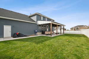 Back of house with a patio, a fenced backyard, stucco siding, and roof with shingles