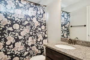 Bathroom featuring vanity and curtained shower