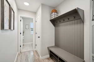 Mudroom with baseboards and light wood finished floors