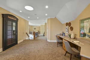 Office featuring recessed lighting, crown molding, light colored carpet, and built in desk