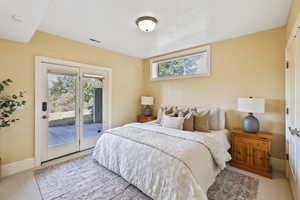 Carpeted bedroom featuring baseboards and access to outside