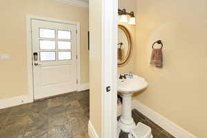Bathroom with baseboards and crown molding