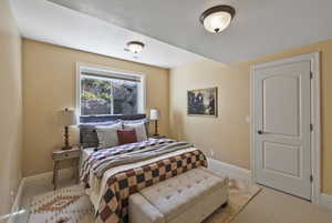Carpeted bedroom featuring baseboards
