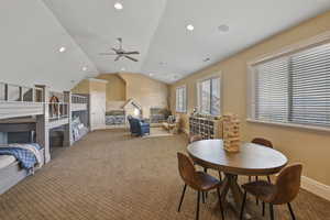 Dining area with lofted ceiling, carpet, recessed lighting, and a ceiling fan