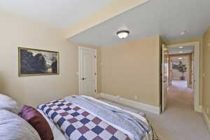 Bedroom featuring light colored carpet and baseboards