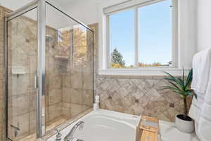 Primary Bathroom with a bath and a shower stall