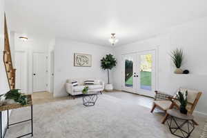 Living area featuring carpet flooring and french doors