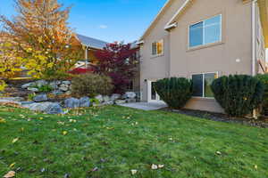 View of grassy yard featuring a patio