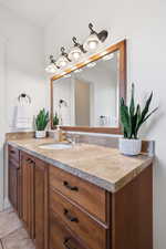 Primary Bathroom with vanity and light tile patterned floors