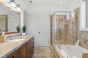 Primary Full bath with vanity, a bath, light tile patterned floors, and a stall shower