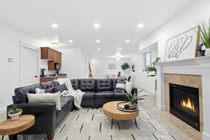 Living room featuring recessed lighting, a tiled fireplace, and light tile patterned floors