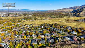 Aerial view of property's location featuring a mountainous background and nearby suburban area