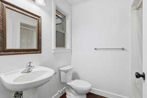 ADU Full bath featuring baseboards and a shower with curtain