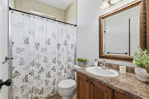Main Bathroom featuring curtained shower, vanity, and light tile patterned floors