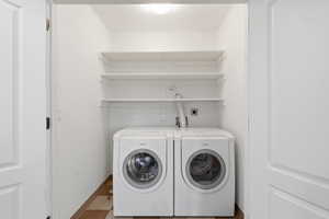 2nd Laundry room with baseboards and washer and clothes dryer