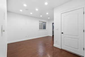 ADU studio bedroom with recessed lighting and dark wood-type flooring