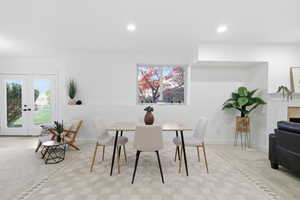 Dining area with french doors, recessed lighting, and a tiled fireplace