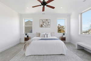 Primary Bedroom with carpet flooring, a ceiling fan, multiple windows, and recessed lighting