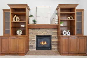 Living area featuring a glass covered fireplace and light tile patterned floors