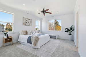 Primary Bedroom with multiple windows, a ceiling fan, ornamental molding, and recessed lighting