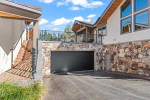 View from clubhouse entrance to garage and steps to courtyard and front door of unit