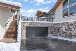 View of patio featuring concrete driveway and a garage