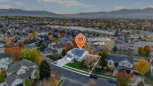 Aerial perspective of suburban area with mountains and property boundaries highlighted