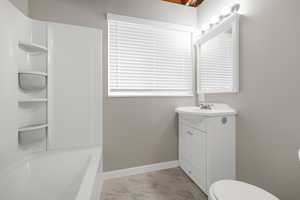 Bathroom featuring vanity and light marble finish floors
