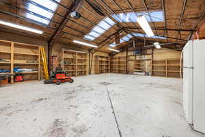 Garage featuring freestanding refrigerator and a garage door opener