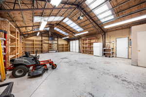Garage featuring freestanding refrigerator and a garage door opener