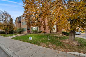 View of front facade featuring brick siding and a front lawn