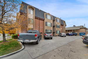 View of building exterior with uncovered parking