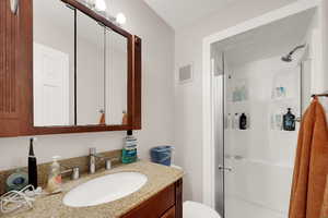Bathroom featuring vanity and a shower stall
